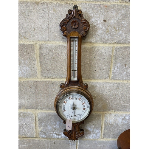 228 - An Edwardian inlaid mahogany tear drop mantel clock, height 34cm and a carved oak aneroid wheel baro... 