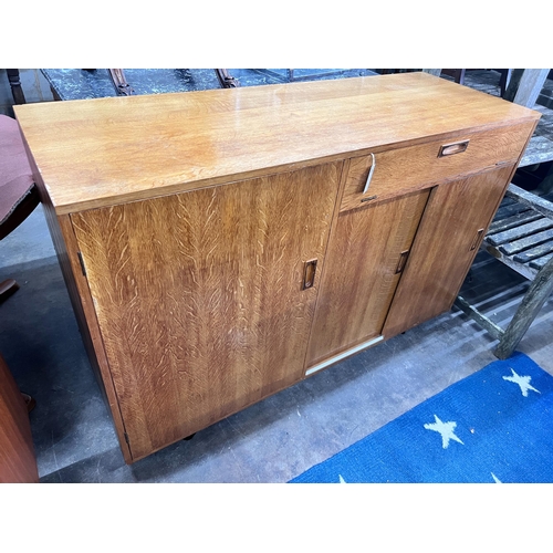 249 - A mid century golden oak sideboard, width 140cm *Please note the sale commences at 9am.