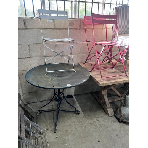 26 - A circular metal and wrought iron garden table, diameter 90cm and three chairs *Please note the sale... 