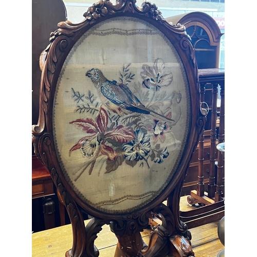 262 - A Victorian carved walnut fire screen with needlework parrot banner, width 56cm, height 99cm *Please... 