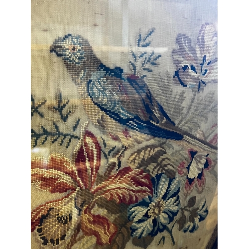 262 - A Victorian carved walnut fire screen with needlework parrot banner, width 56cm, height 99cm *Please... 