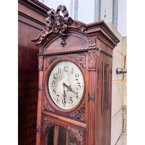 297 - An early 20th century French carved walnut thirty hour longcase clock, height 224cm *Please note the... 