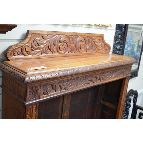 318 - A late Victorian carved oak open bookcase, width 106cm *Please note the sale commences at 9am.... 