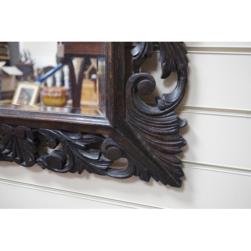 320 - An Edwardian foliate carved oak wall mirror, width 81cm, height 64cm *Please note the sale commences... 