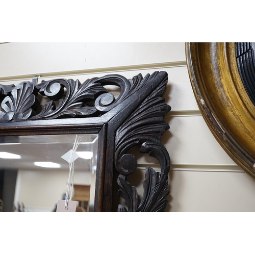 320 - An Edwardian foliate carved oak wall mirror, width 81cm, height 64cm *Please note the sale commences... 