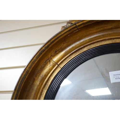 322 - A Regency ebonised and giltwood convex wall mirror, height 87cm *Please note the sale commences at 9... 