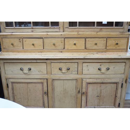 336 - A 19th century pine dresser base of small proportions with an associated glazed cabinet top, width 1... 