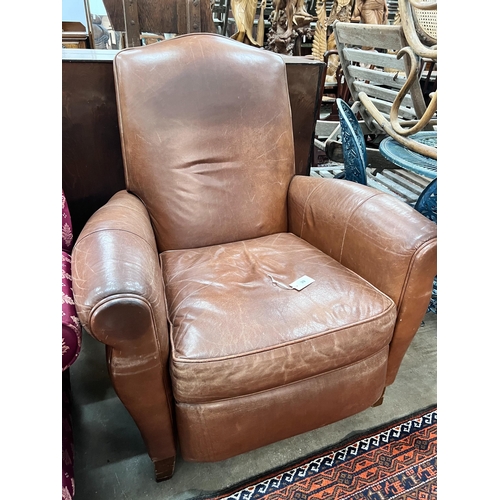 39 - A contemporary tan leather reclining armchair with integral footrest, width 92cm, height 104cm *Plea... 