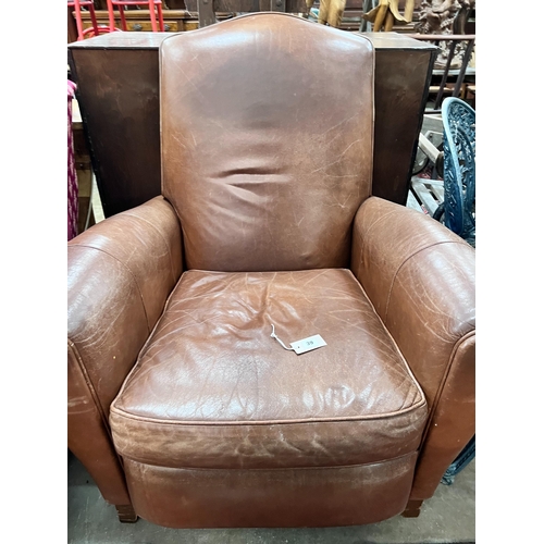 39 - A contemporary tan leather reclining armchair with integral footrest, width 92cm, height 104cm *Plea... 