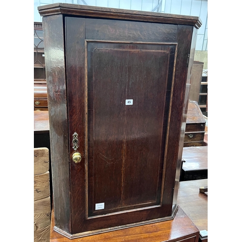 45 - A George III oak hanging corner cupboard, width 69cm, depth 40cm, height 97cm *Please note the sale ... 