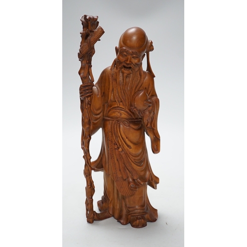 566A - An early 20th century Chinese carved boxwood figure of Shou Lao, 26cm