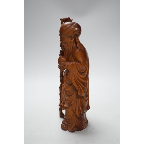 566A - An early 20th century Chinese carved boxwood figure of Shou Lao, 26cm