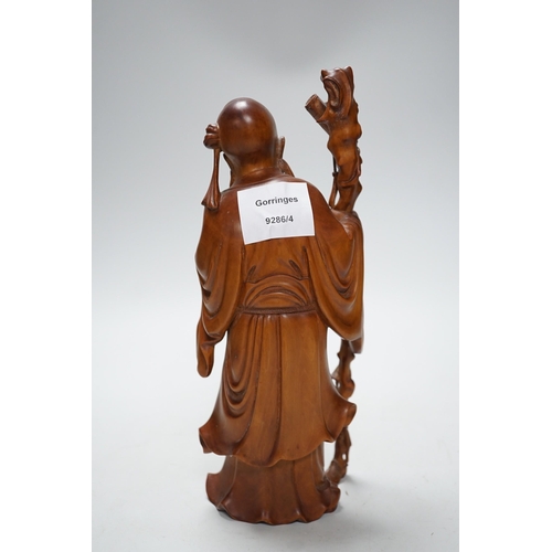 566A - An early 20th century Chinese carved boxwood figure of Shou Lao, 26cm