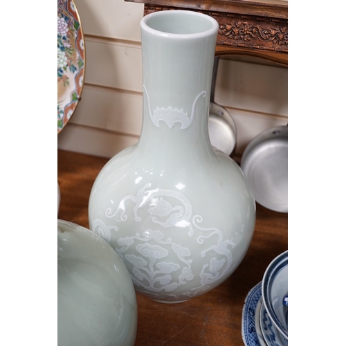 618A - A pair of Chinese white slip decorated celadon glazed bottle vases, mid 20th century, 39cm