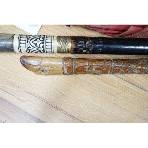 622 - A bone and brass mounted ebonised sword stick, a Chinese umbrella and a cane