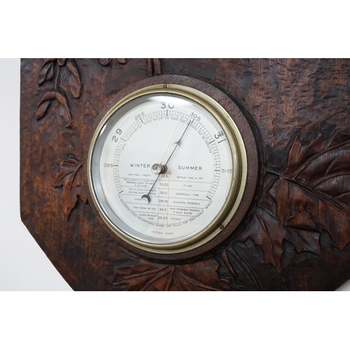 628A - A French carved wood aneroid barometer, 60 x 36cm