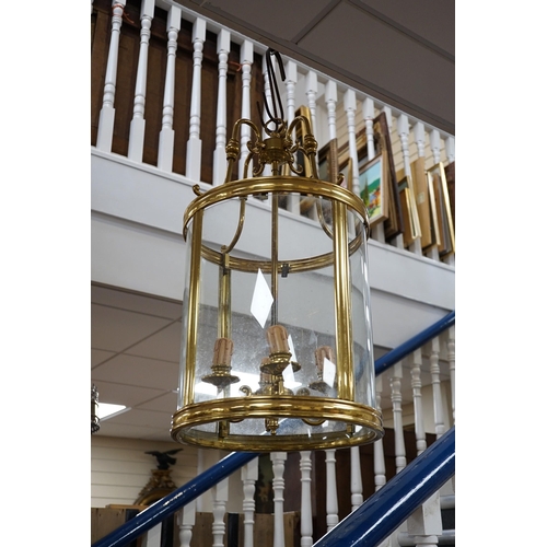 639 - A four light brass hall lantern, 62cm tall