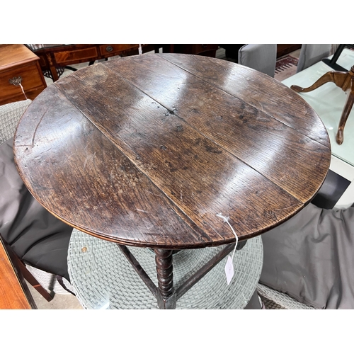 76 - A circular oak bobbin legged table, diameter 73cm, height 61cm *Please note the sale commences at 9a... 