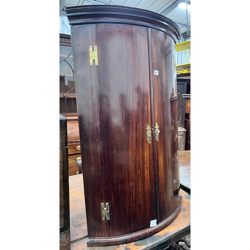 87 - A George III mahogany bowfront hanging corner cabinet, width 73cm, depth 51cm, height 114cm *Please ... 