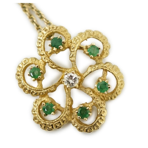 987 - A modern yellow metal, emerald and diamond set stylised flower head pendant, 25mm, on a 375 chain, 4... 