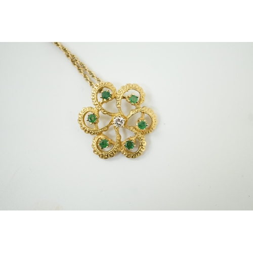 987 - A modern yellow metal, emerald and diamond set stylised flower head pendant, 25mm, on a 375 chain, 4... 