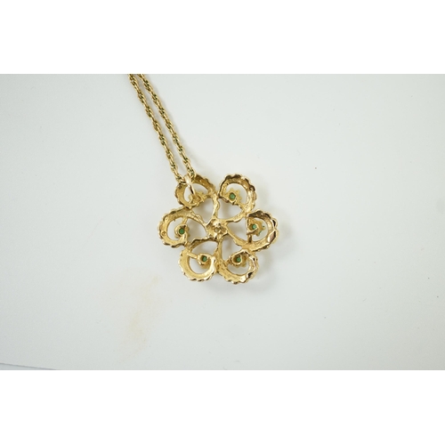 987 - A modern yellow metal, emerald and diamond set stylised flower head pendant, 25mm, on a 375 chain, 4... 