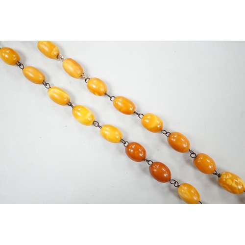 995 - A single strand graduated oval amber bead necklace, 44cm, gross weight 16 grams.