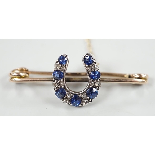 997 - A late Victorian yellow metal. sapphire and diamond cluster set horseshoe bar brooch, 42mm, gross we... 