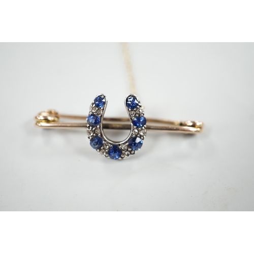 997 - A late Victorian yellow metal. sapphire and diamond cluster set horseshoe bar brooch, 42mm, gross we... 