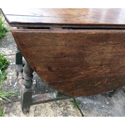 105 - An 18th century oak gateleg dining table, the turned underframe with traces of old paint, length 123... 