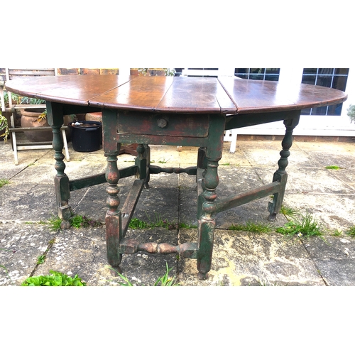 105 - An 18th century oak gateleg dining table, the turned underframe with traces of old paint, length 123... 