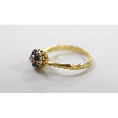 981 - A modern yellow metal, sapphire and diamond cluster set ring, size M, gross weight 2.8 grams.