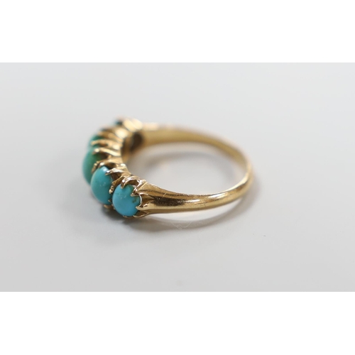 987 - A yellow metal and graduated five stone cabochon turquoise set half hoop ring, size G/H, gross weigh... 