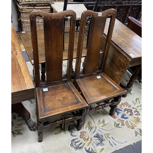 187 - A pair of William and Mary oak chairs, c.1690, the solid splats and seats on turned legs, joined by ... 