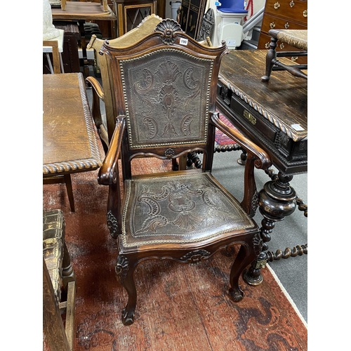 190 - A pair of continental Spanish style carved elbow chairs with tooled leather backs and seats, width 6... 