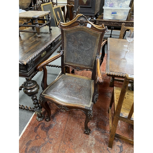 190 - A pair of continental Spanish style carved elbow chairs with tooled leather backs and seats, width 6... 