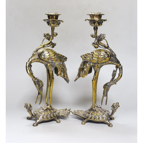 252 - A pair of early 20th century Japanese style silver plated brass crane candlesticks,