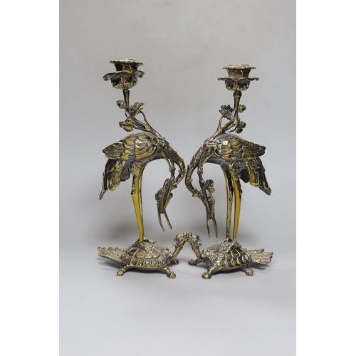 252 - A pair of early 20th century Japanese style silver plated brass crane candlesticks,