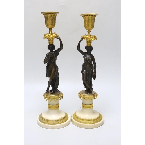275 - A pair of early 20th century bronze, ormolu and alabaster figural candlesticks, 33cm