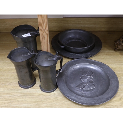 286 - Three 18th century French pewter flagons and chargers, largest 39cm diameter
