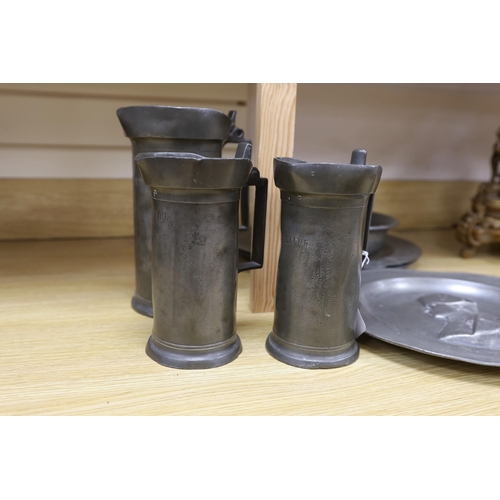 286 - Three 18th century French pewter flagons and chargers, largest 39cm diameter
