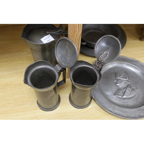 286 - Three 18th century French pewter flagons and chargers, largest 39cm diameter