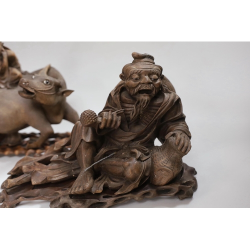 287 - Two Chinese carved hardwood figure groups on stands, early 20th century, largest 30cm long