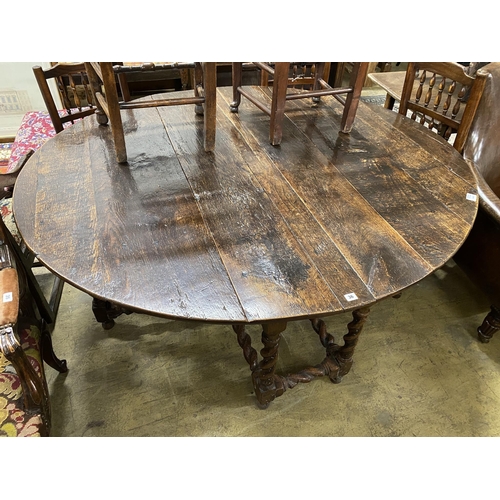 36 - An 18th century oak gateleg dining table, length 172cm, extended, width 152cm, height 73cm