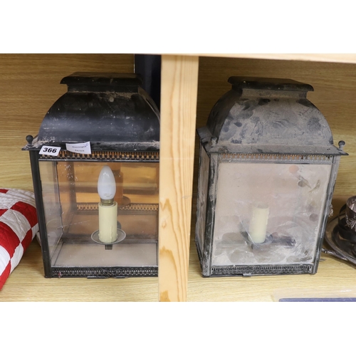 366 - A pair of 19th century black painted tin wall lanterns with three glazed sides. 37cm tall