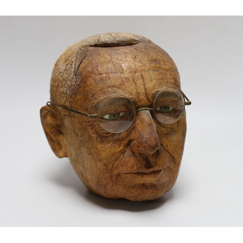 388 - A carved coconut head of a gentleman, 22cm tall