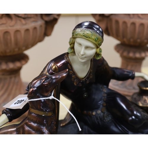 402 - An Art Deco style resin and marble figure group, length of base, 57cm