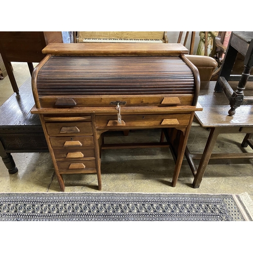 42 - An early 20th century mahogany tambour kneehole writing desk, width 102cm, depth 62cm, height 103cm... 