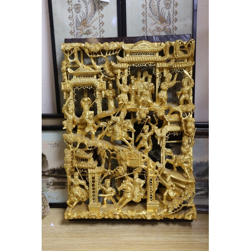 450 - A Chinese carved giltwood  warriors panel, 45cm x 30cm a pair of sleeve bands and three framed Chi... 