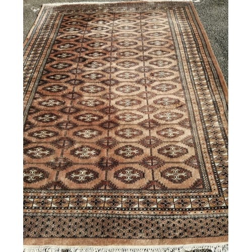 63 - A Bokhara peach ground carpet, 280 x 186cm